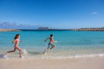 NCL Harvest Caye Children Running Beach Family ©Erin Kunkel.jpg